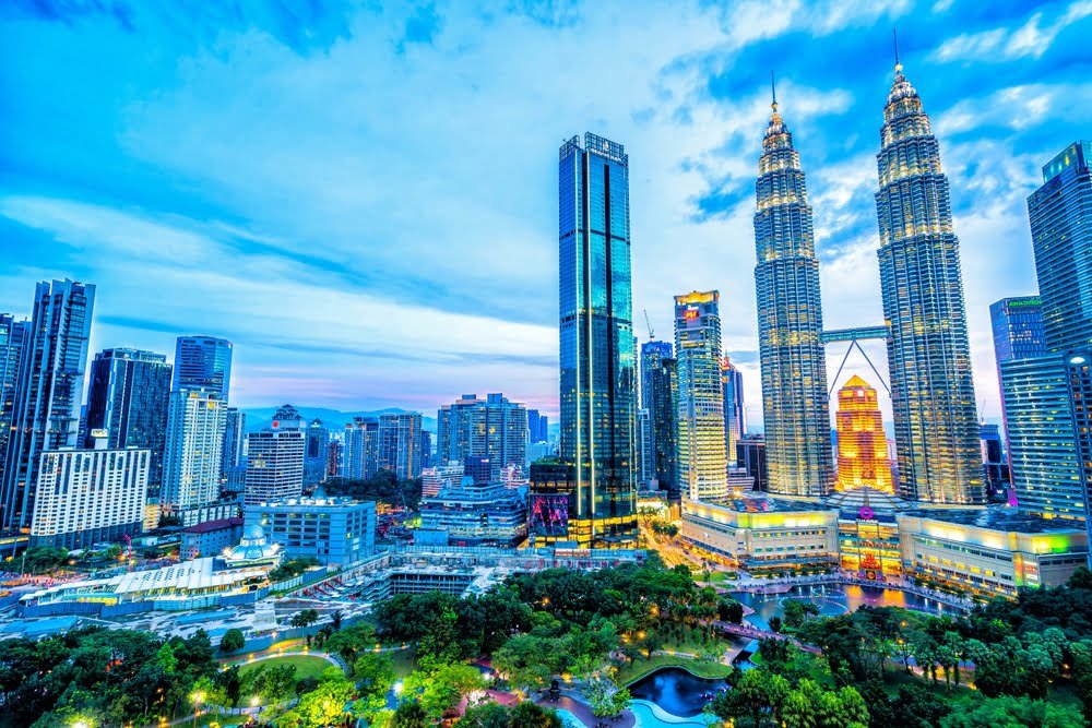 The Petronas Twin Towers rise majestically in the background of a vibrant Kuala Lumpur skyline, symbolising Malaysia Construction Safety Standards.