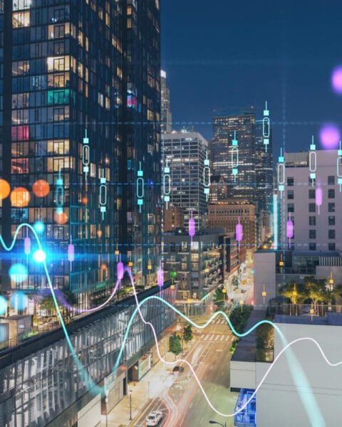 Malaysia Smart City Projects: A cityscape at night with overlayed colorful data and graph lines representing urban analytics.